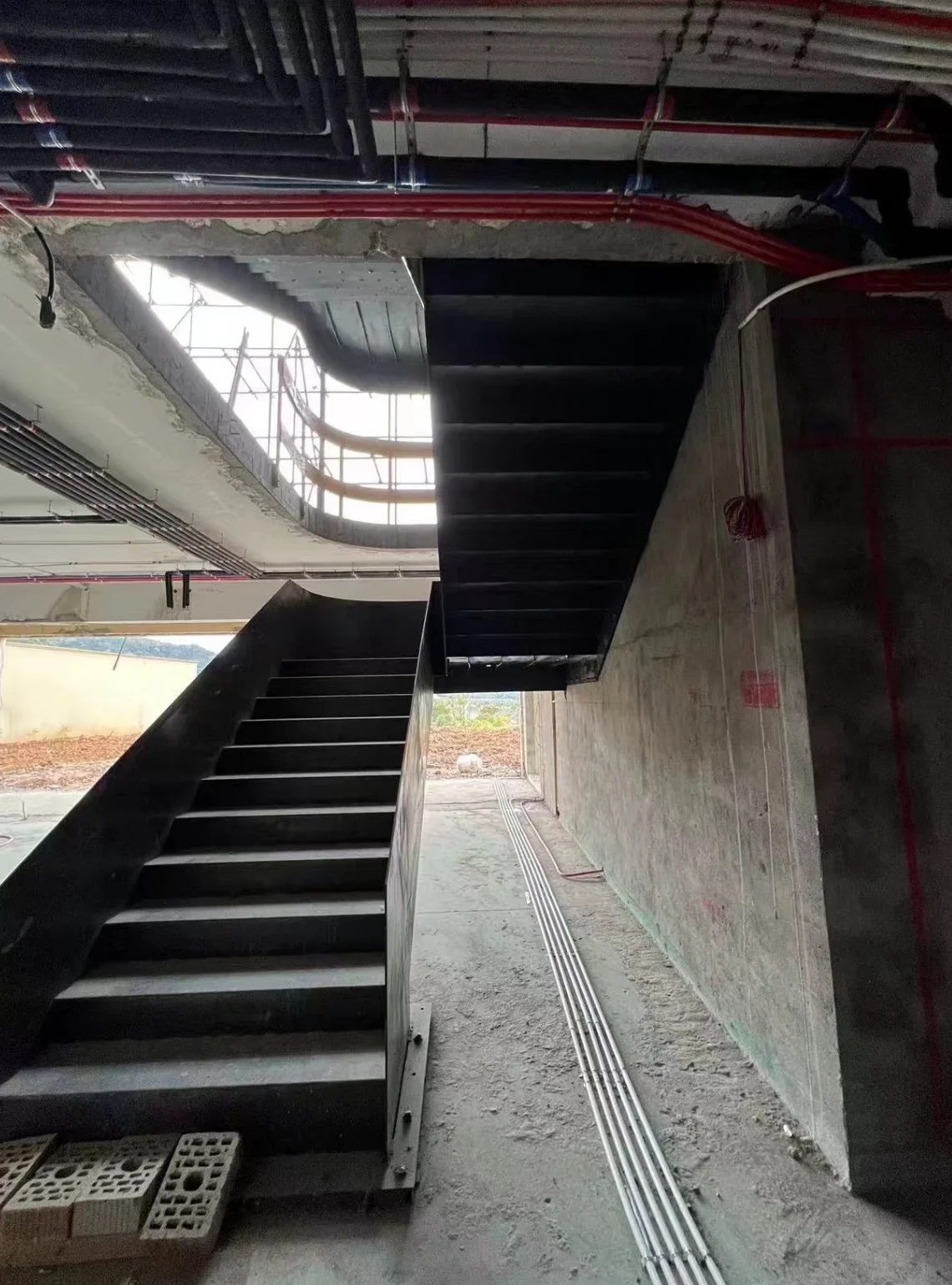 Structural connection and installation detail of a custom curved steel staircase