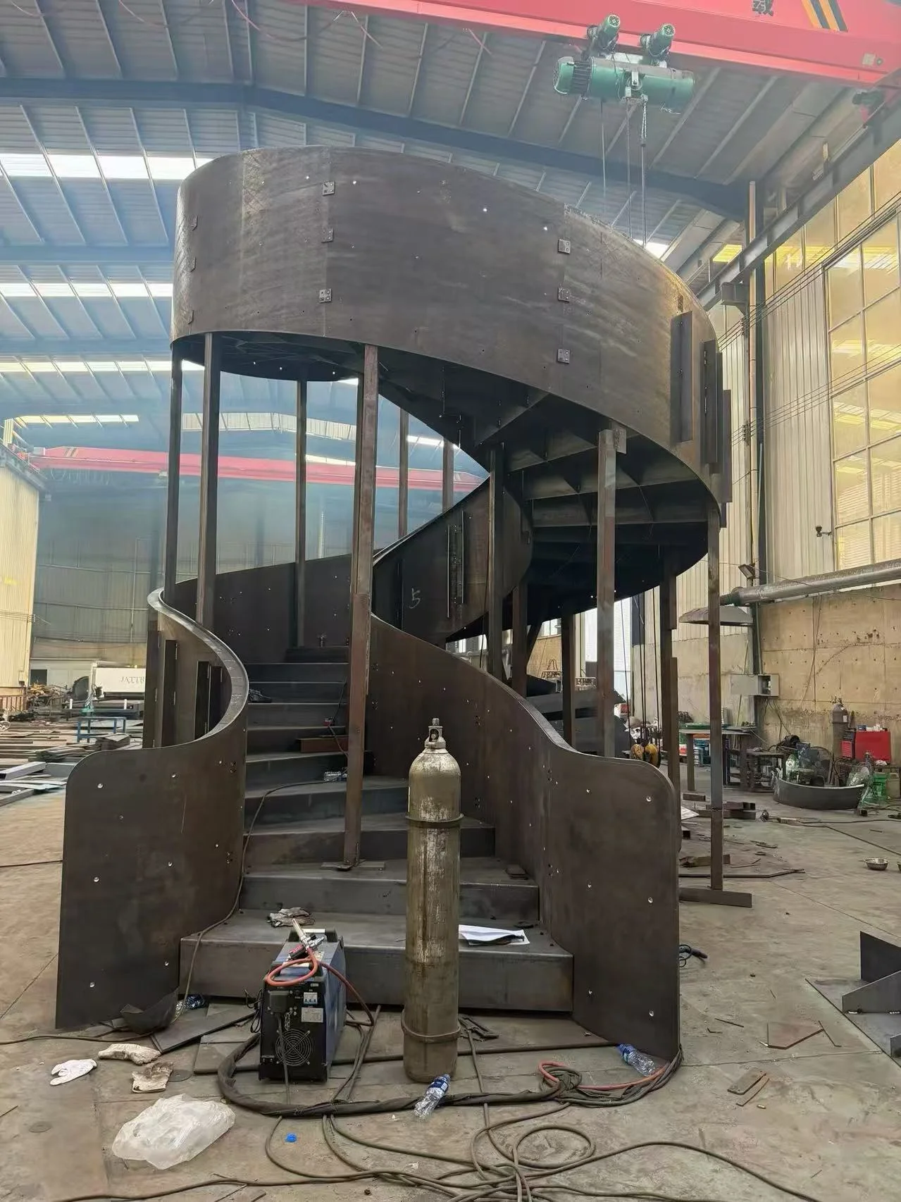 Custom helical steel staircase fabrication in the Kingston workshop