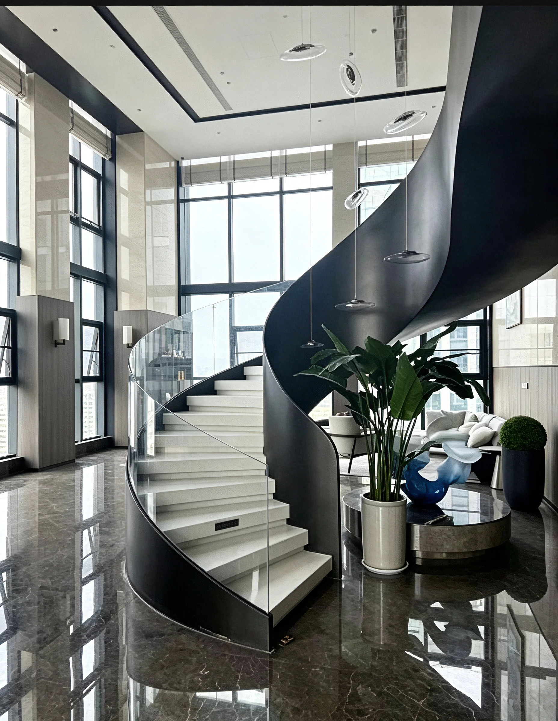 Custom curved steel plate helical staircase designed for a luxury residence