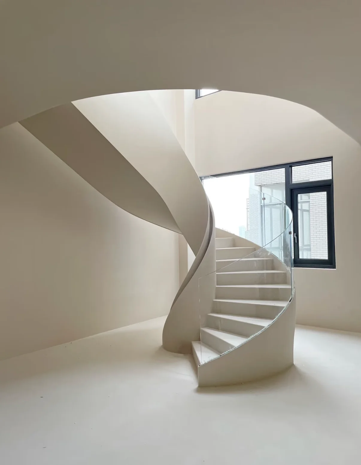 Minimalist sculptural curved staircase designed as an architectural centerpiece