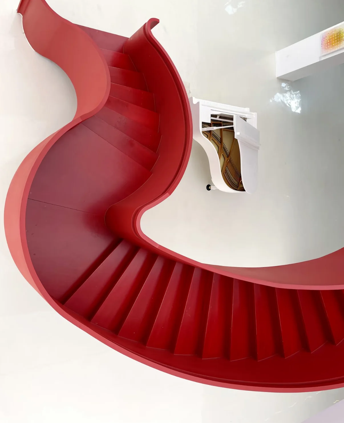 Red sculptural curved staircase viewed from above