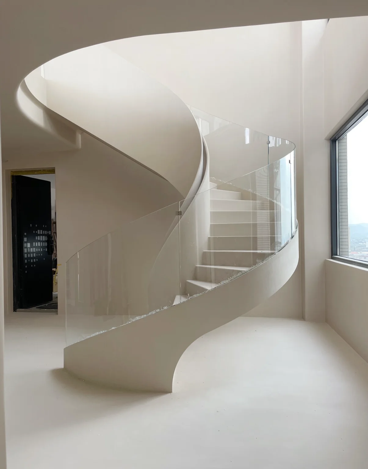 White sculptural staircase designed as an architectural form in a luxury residence